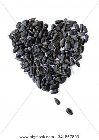 Black Small Sunflower Seeds. Seeds In The Shape Of A Heart And A Month. Handful Of Seeds.