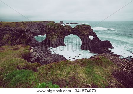 Amazing Seascape, Gatklettur Basalt Rock Arch At The Volcanic Cliff, Atlantic Coast Of Arnarstapi In