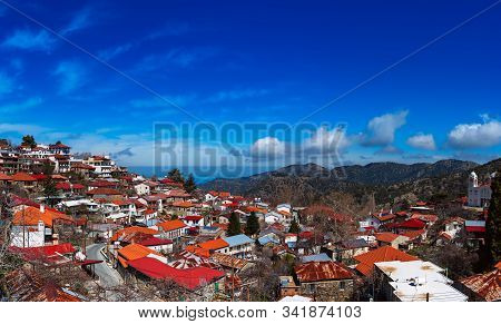 Pedoulas Village On Cyprus In Troodos Mountains With Blue Sky And Copy Space. Panoramic View.