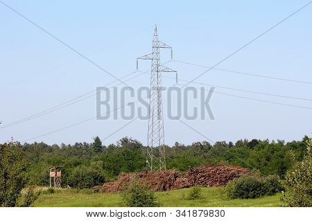 Power Line Utility Pole Made Of Metal Pipes With Four Electrical Wires Connected With Tall Transpare