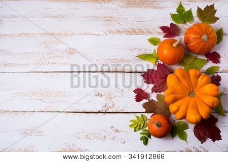 Rustic Fall Decor With Pumpkins, Red And Green Leaves