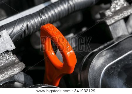 Red Oil Dipstick In Car Engine. Measuring Level Of Engine Oil. Dipstick Oil Level Gauge With Red Col