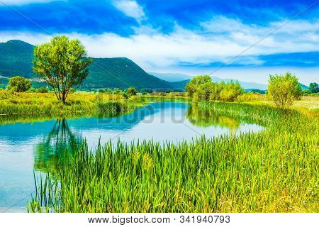 Croatia, Beautiful Scenic Landscape, Gacka River Among Grass Banks In Lika Region