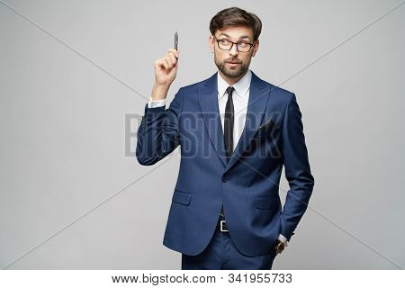 Studuo Shot Of Thinking Solving Problem Businessman Wearing Suit Holding Pen