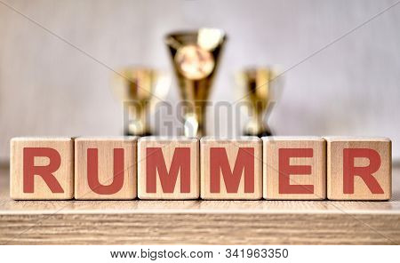 The Text - Rummer On Wooden Cubes, In The Background Of The Cups