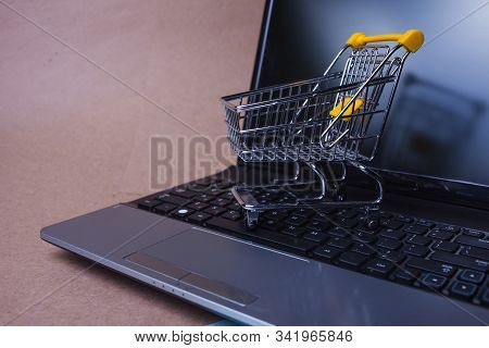 End Of Online Sales, Concept. Online Shopping, Shopping Cart On Laptop Keyboard. Shopping In Online 
