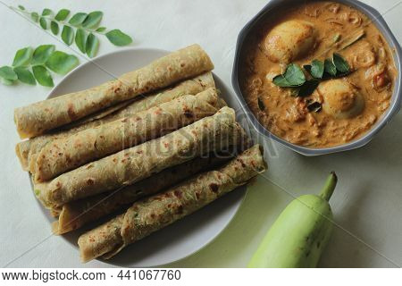 Indian Flat Bread Made Of Whole Wheat Flour, Grated Bottle Guard, Yogurt And Spices Served With Boil