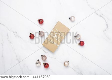 Gift, Decorative Balls On A Marble Background. Top View, Flat Lay.