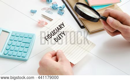 Paper With Fiduciary Duty In Hand On A Table