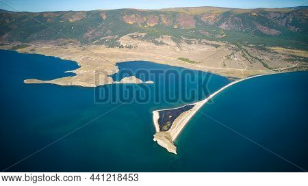 Lake Baikal From The Air. View Of The Bay Near The Village Of Kurma, Cape Uyuga. The Small Sea At Th