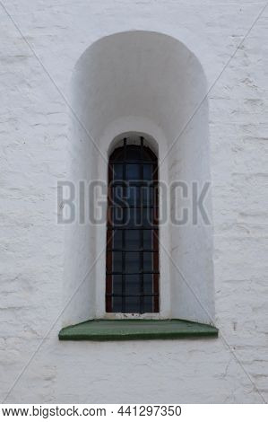 Antique Window With Lattice In A Stone Wall