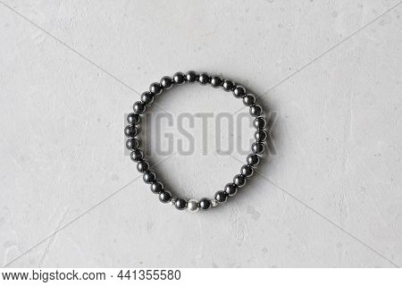 Hematite Bracelet. A Bracelet Made Of Stones On A Hand From Natural Stone Hematite. Bracelet Made Of