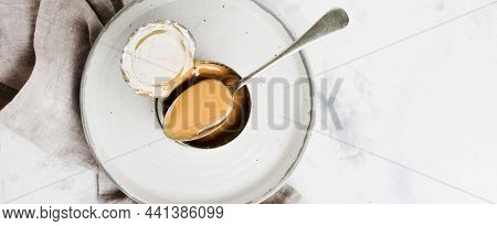 Condensed Or Evaporated Milk In Open Tin On Light Concrete Table. Top View.