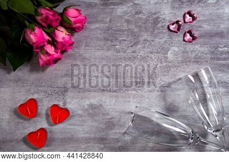 Festive Background With Roses And Heart Shape Candles Next To Couple Of Wineglasses. Holiday Decorat