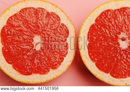 Grapefruit Cut In Half On Pink Background, Top View
