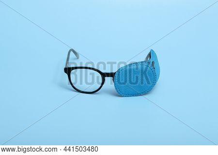 Children's Glasses With Occluder On A Colored Background. Lazy Eye. Amblyopia
