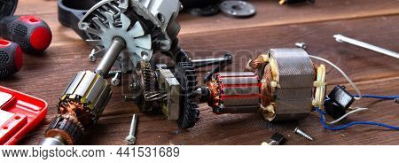 Details Of Electrical Appliance And Repair Tools On A Wooden Table In A Repair Shop