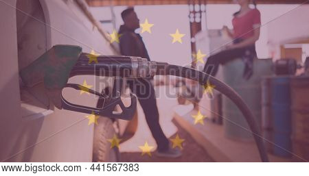 Multiple exposure of european union flag with pump fueling vehicle against couple at gas station. digital composite, identity and lifestyle.