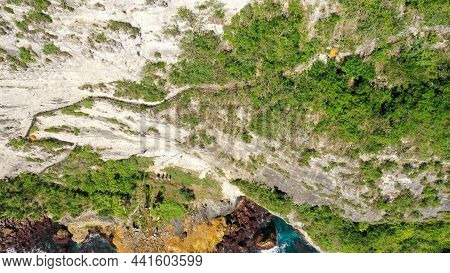 Extremely Dangerous Footpath On A Cliff Wall To Seganing Waterfall. Rocky Cliff Shore And Hiking Tra
