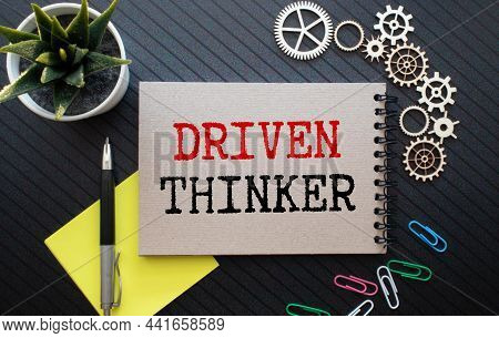 Closeup On Businessman Holding A Card With Text Driven Thinker, Business Concept Image With Soft Foc