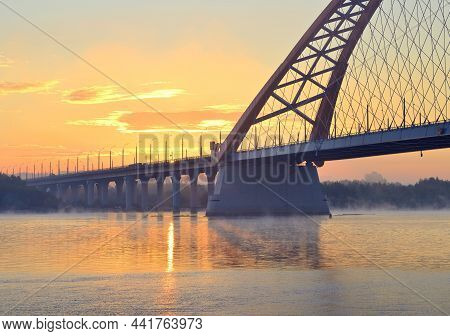 Bugrinskij Bridge At Dawn. Automobile Bridge Over The Great Siberian River Ob In The Morning Fog