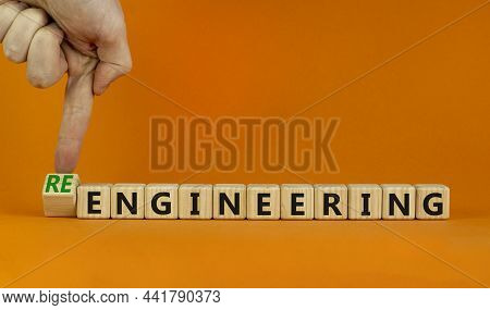 Engineering Or Reengineering Symbol. Engineer Turns Cubes And Changes Words Engineering To Reenginee