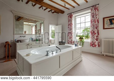 Wimbish, England - July 30 2019: Bathroom In Established English Country Home. Twin Sinks On Cupboar