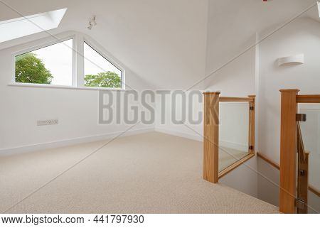 Cambridge, England - July 31 2019: Empty Attic Loft Room Within Renovated Home With Natural Wood Sta
