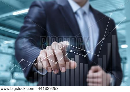 Business Man Makes Financial Analytics Graph Of Financial Growth On A Virtual Computer Screen.