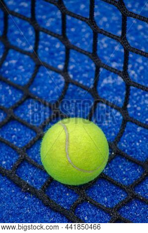A Ball Over The Net Of A Paddle Tennis Court