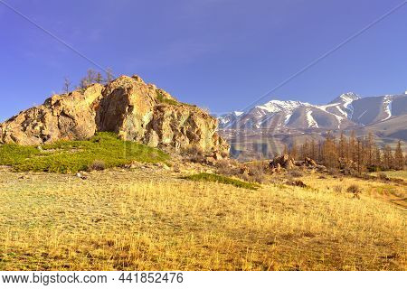 The Kurai Range In The Altai Mountains. A Rocky Cliff In The Kurai Steppe, Snow-capped Mountains In 