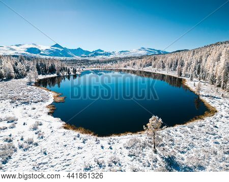 Kidelu Lake In Altai Mountains, Siberia, Russia. Snow-covered Trees And Mountains. Aerial Drone View