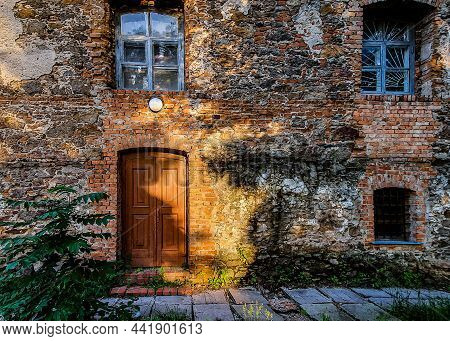 Residential Building Of The Last Century. Background Of Shabby And Dirty Brickwork With Old Wooden W