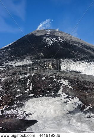 View Of The Slope Of An Active Volcano On The Kamchatka Peninsula. A White Plume Of Volcanic Gases O