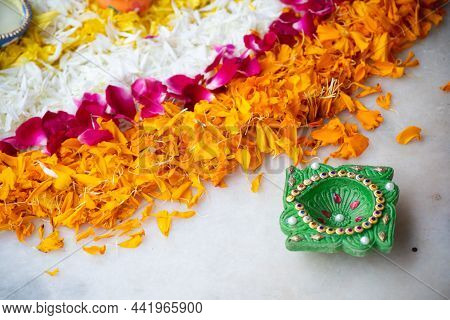 Close Up Shot Of Flower Petal Rangoli With Handmade Painted Earthenware Brown And Green Diya Lamp Us