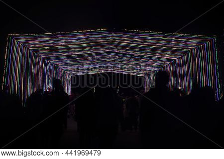 People Walking Through Tunnel Of Lights At The Christmas Fantasy Of Lights In Los Gatos, California.