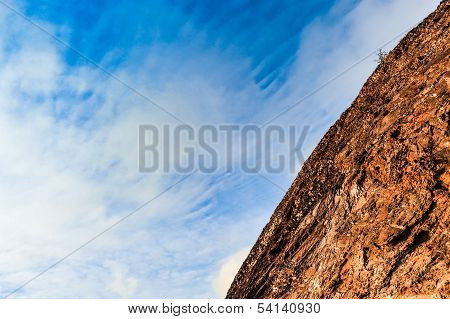 Rock Formation Against A Blue Cloudy Sky