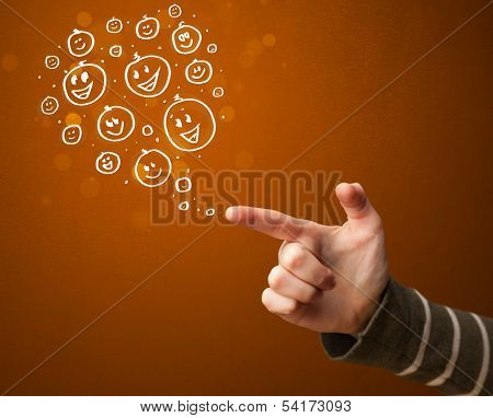 Group of happy hand drawed smiley faces coming out of gun shaped hands