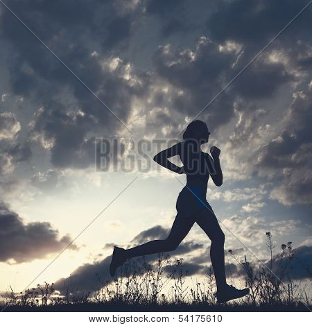 Silhouette woman run under blue sky with clouds and sun