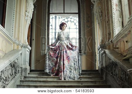 Beautiful woman standing on the top of a stairway 