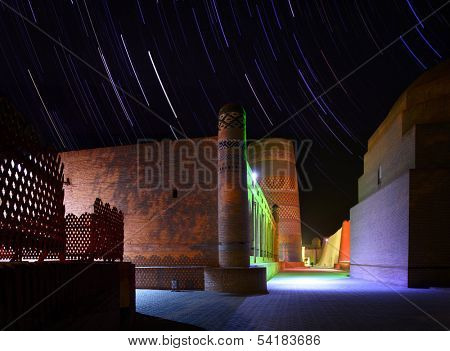 Ancient town of Itchan Kala at night with star trails. The city of Khiva, Uzbekistan