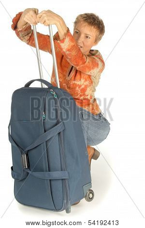 Woman Trying To Colse Suitcase