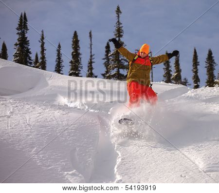 Snowboarder jumping through air with deep blue sky in background