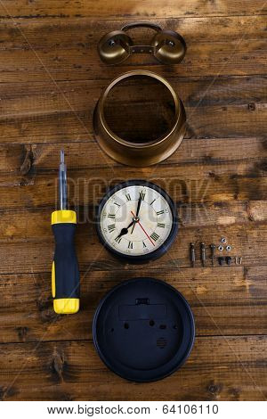 Repair clock on wooden background