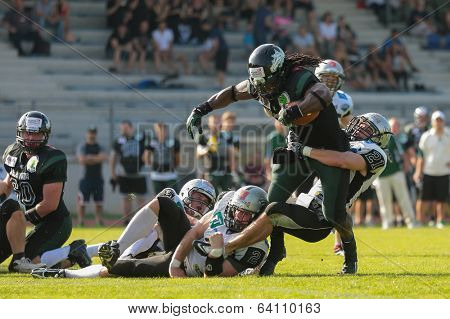VIENNA,  AUSTRIA - JUNE 8 DB Markus Krause (#21 Raiders) tackles RB Tunde Ogun (#1 Dragons) during the AFL football game on June 8, 2013 in Vienna, Austria.