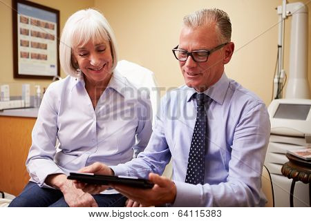 Cosmetic Surgeon Discussing Proceedure With Client In Office