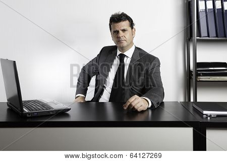 Businessman Sitting At Desk