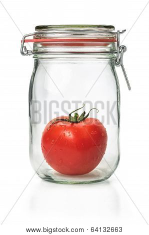 Fresh tomato in a canning jar on a white background
