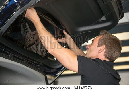 Car Wrapper Attaching Tinting Foil To Car Window
