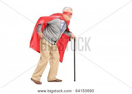 Senior with red cape and mask walking with cane isolated on white background